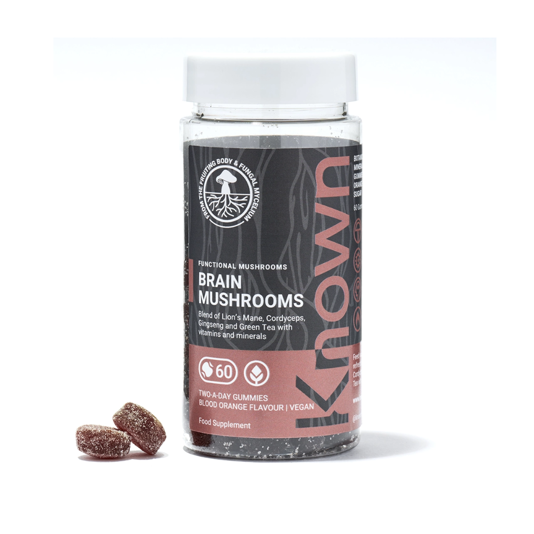 "Front view of Known Brain Mushrooms Gummies VEGAN, 60-count bottle with a couple of gummies around it."