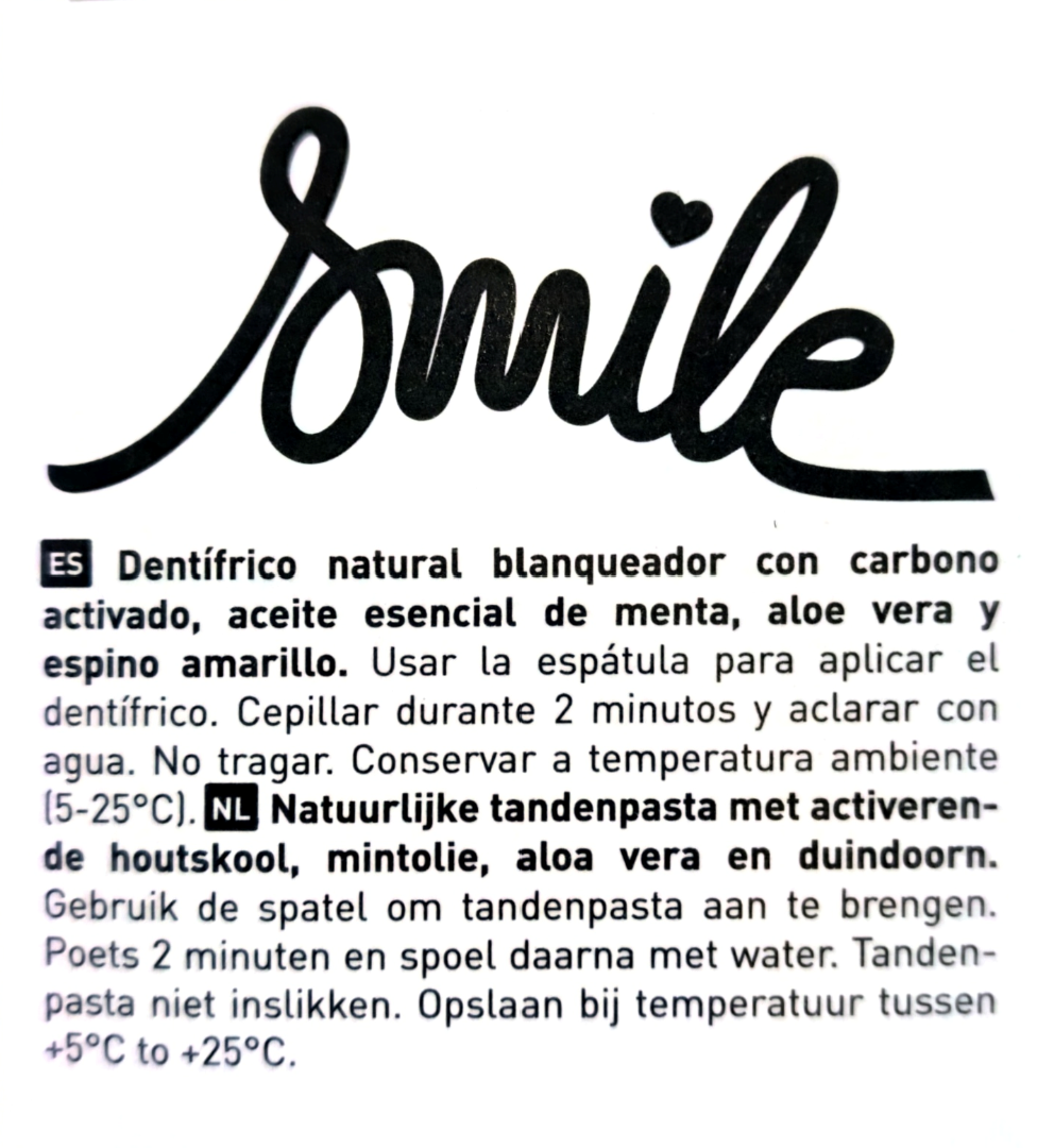 A close-up of a white product box or booklet cover showing the brand name 'Smile' in large black script at the top, followed by Spanish and Dutch product instructions in smaller black text.