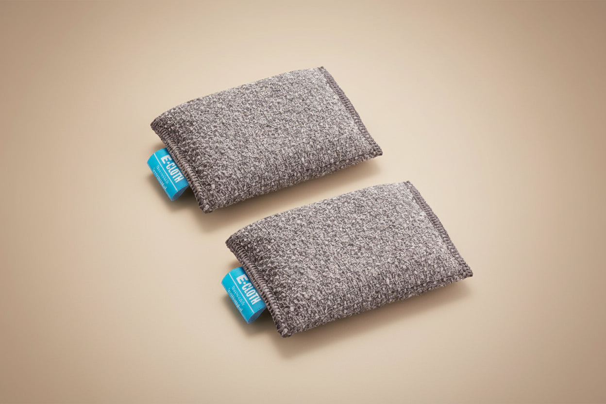 Two gray fabric wristbands with blue tags on a white background