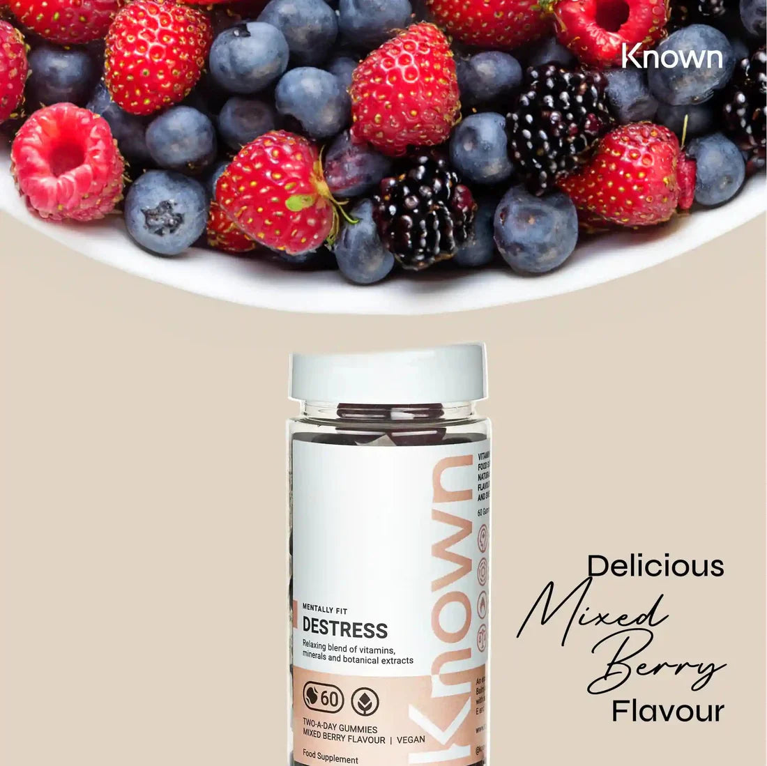 "Known Destress Gummies VEGAN bottle surrounded by berries, emphasizing the delicious Mixed Berry flavor."