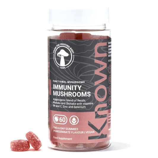 "Front view of Known Immunity Mushrooms Gummies VEGAN, 60-count bottle with a couple of gummies around it."
