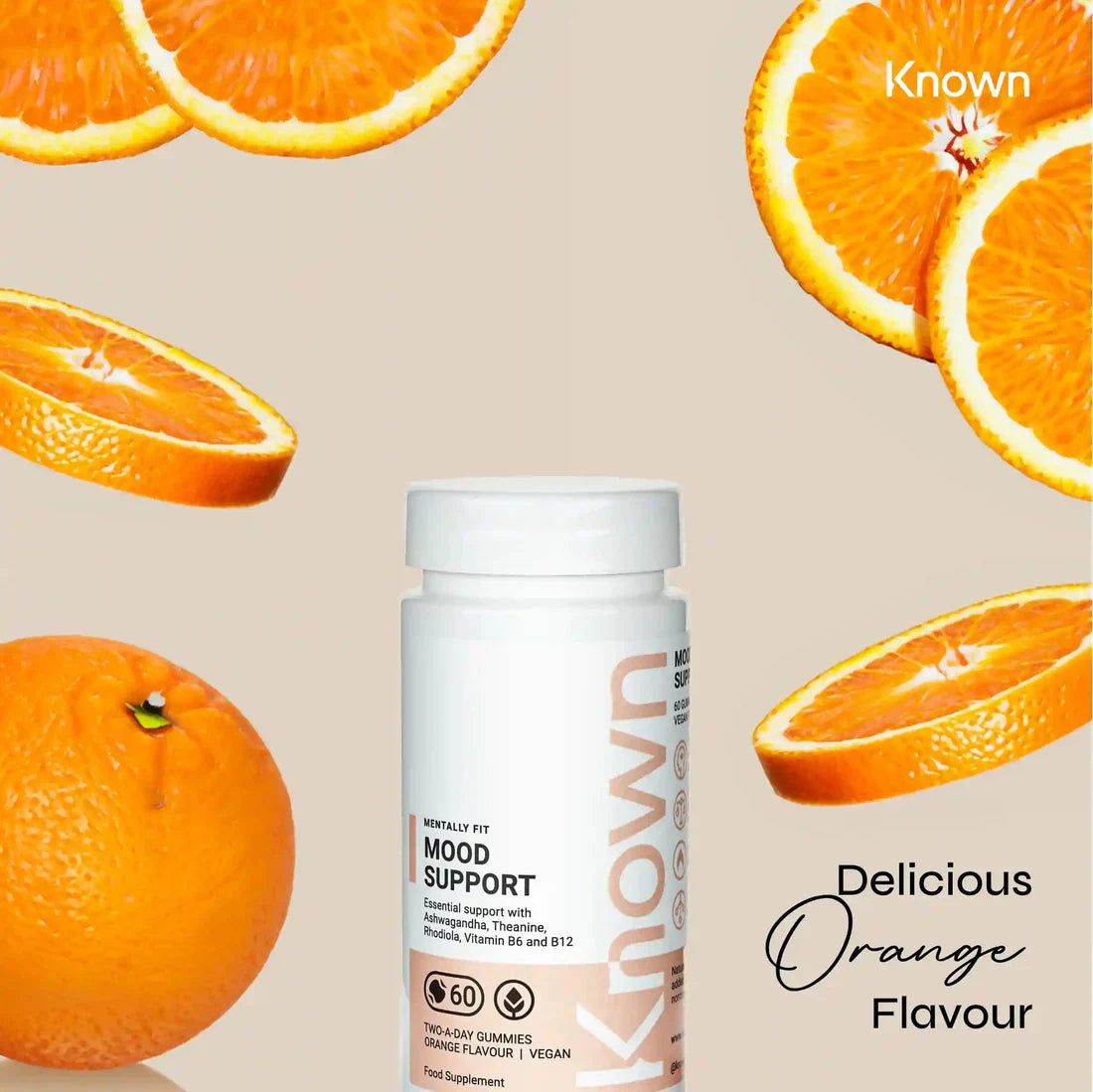 "Known Mood Mushrooms Gummies VEGAN bottle surrounded by fresh oranges, emphasizing the delicious natural flavor."