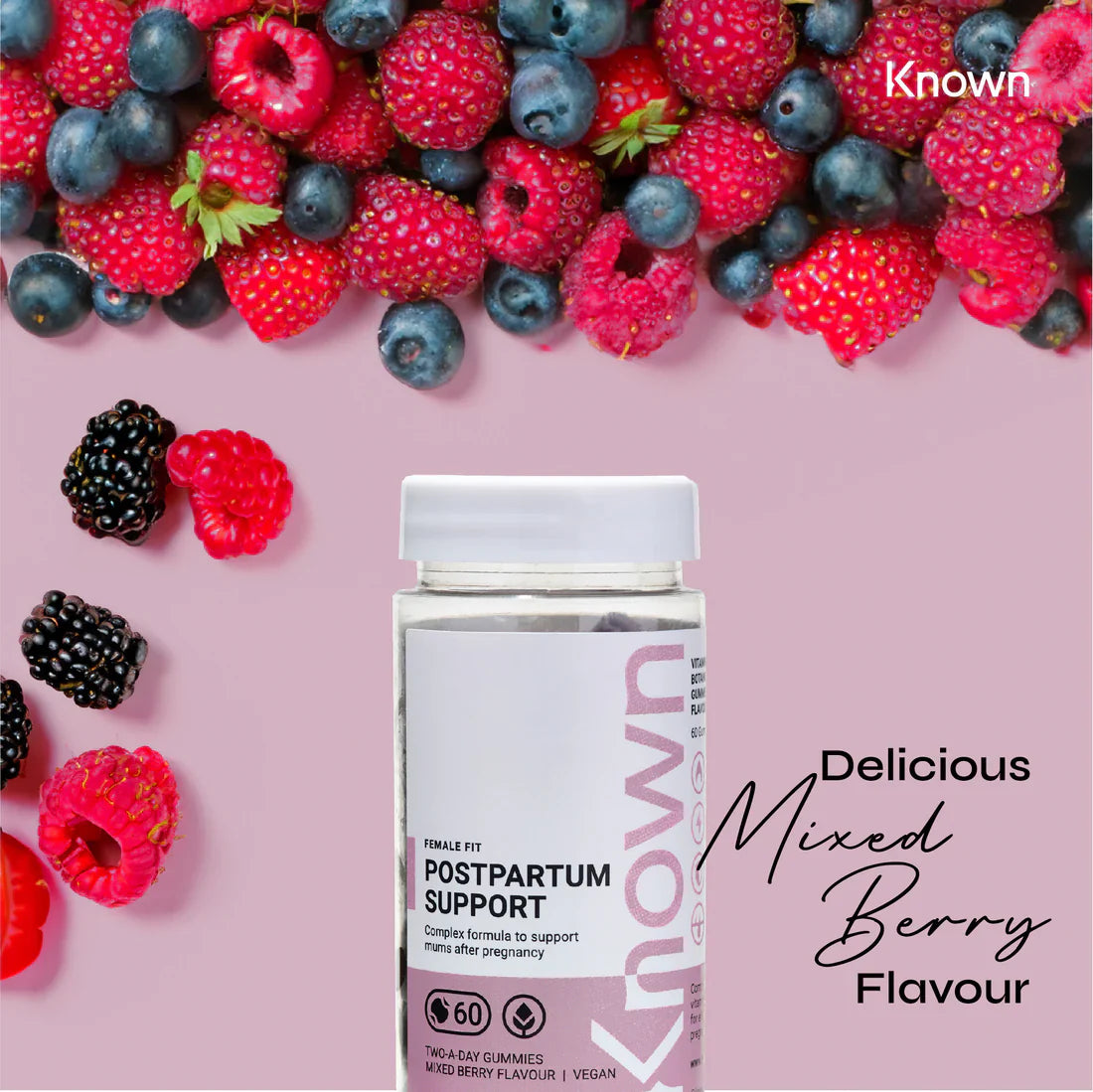 "Known Postpartum Support Gummies VEGAN bottle surrounded by fresh mixed berries, emphasizing the delicious natural flavor."