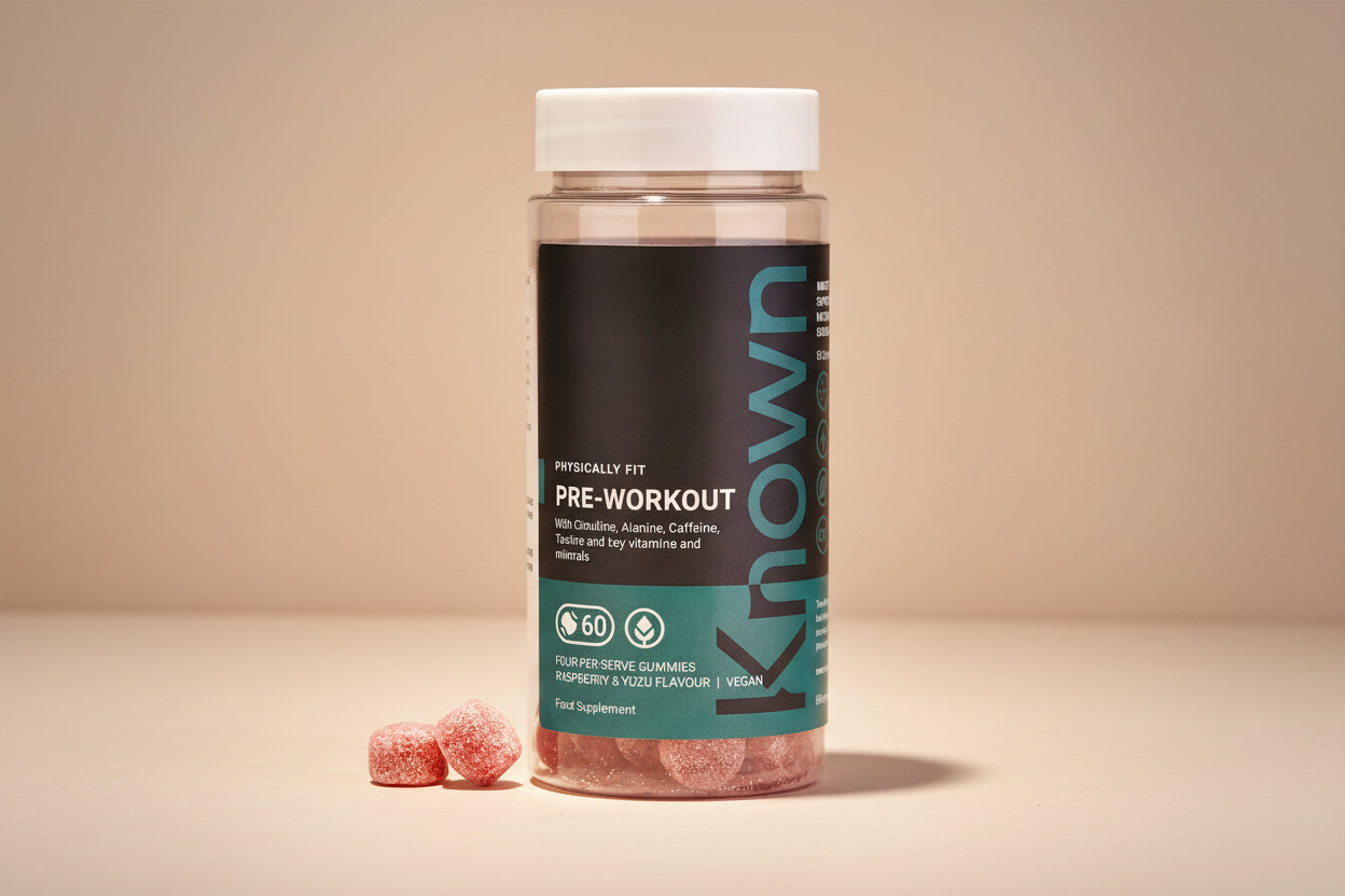 "Front view of Known Pre-Workout Gummies VEGAN, 60-count bottle with a couple of gummies around it."