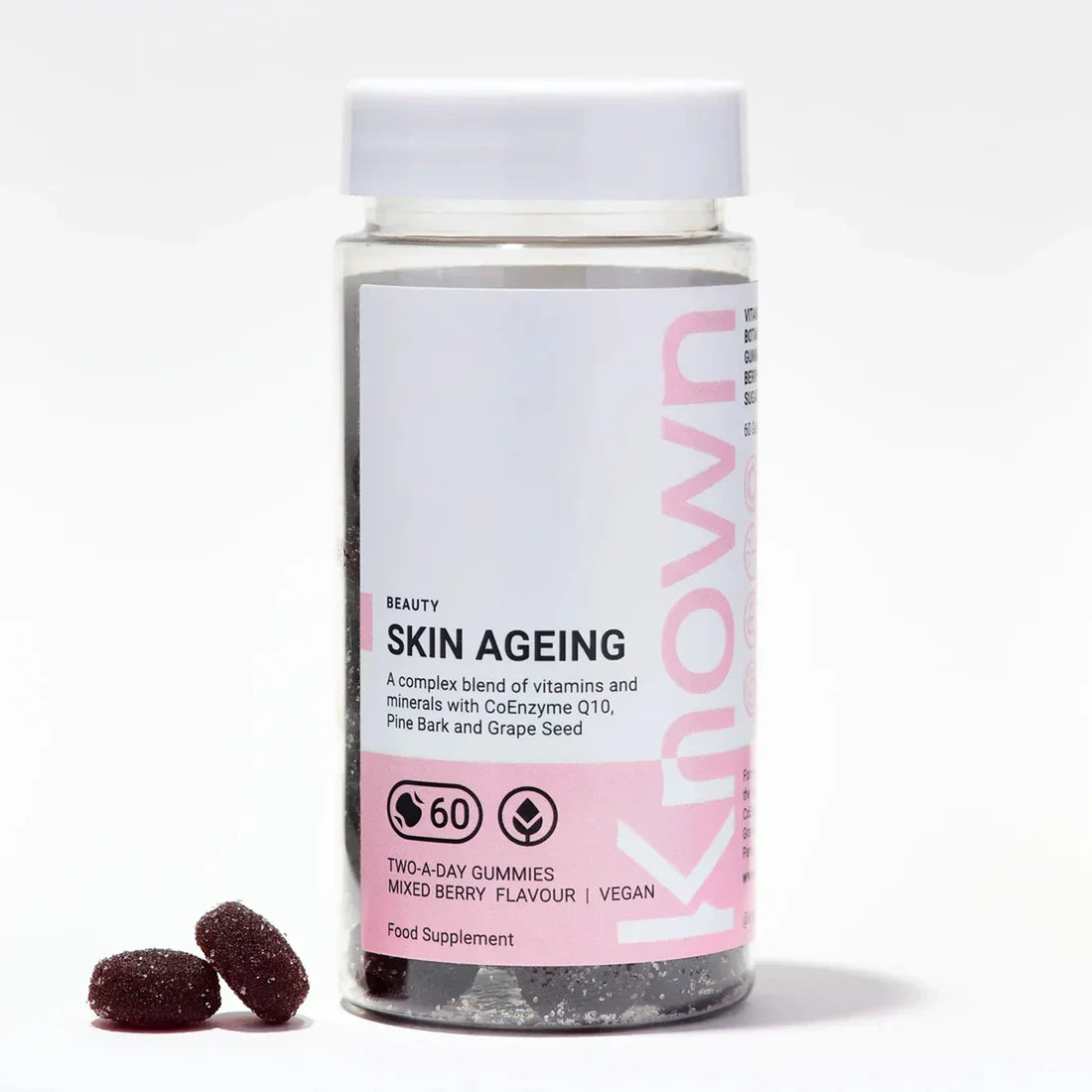 "Front view of Known Skin Ageing Gummies VEGAN, 60-count bottle with a couple of gummies around it."