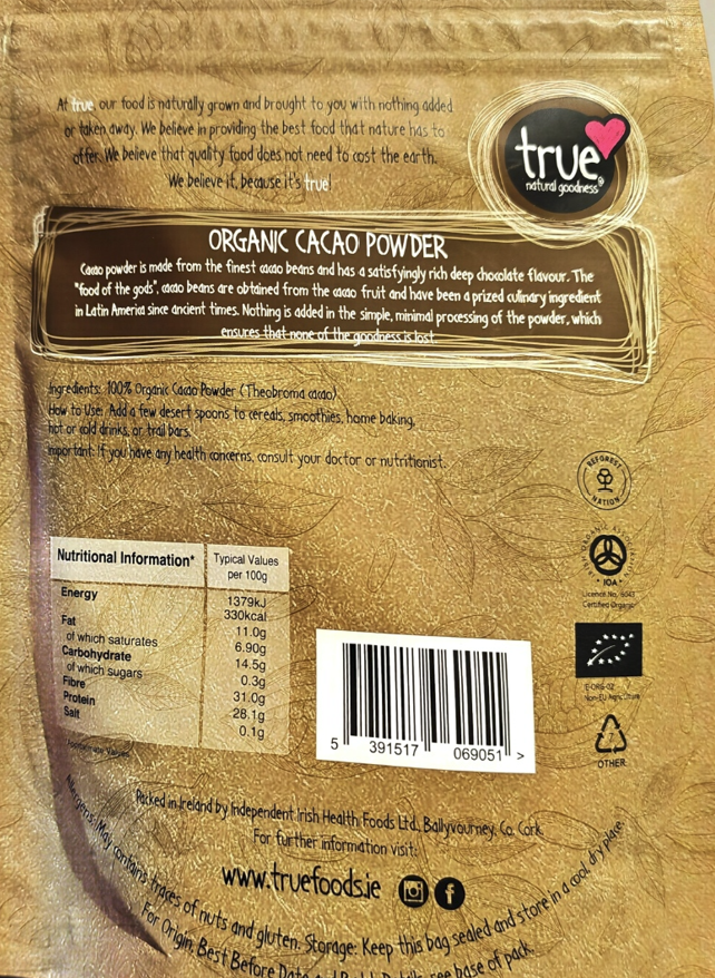 Back of a brown paper bag of True Organic Cacao Powder, showing product details, nutritional information, a barcode, and logos including True Organic Cacao and the EU organic certification mark.