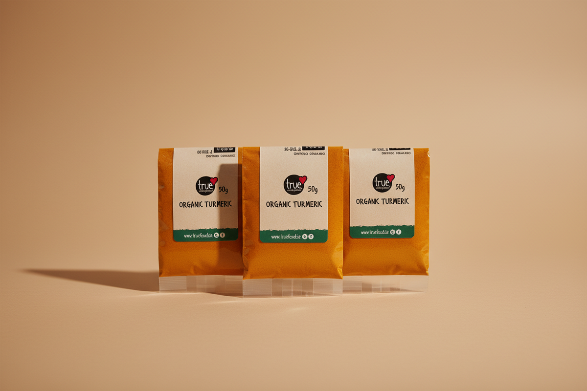 Three small packets of True Food Co. organic turmeric powder, 50g each, sealed in clear plastic packaging with white labels.