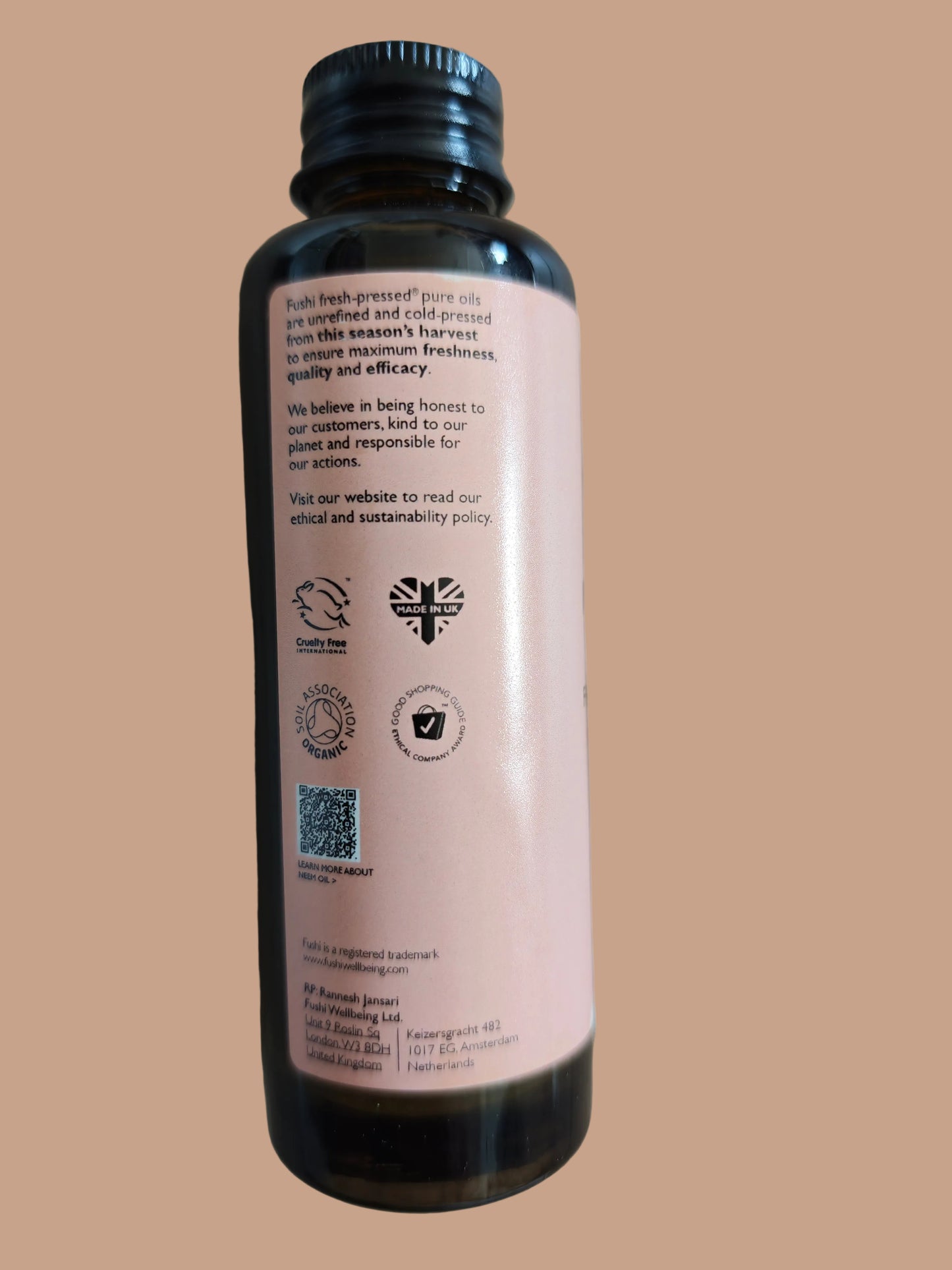 Bottle with a pink label on a wooden surface