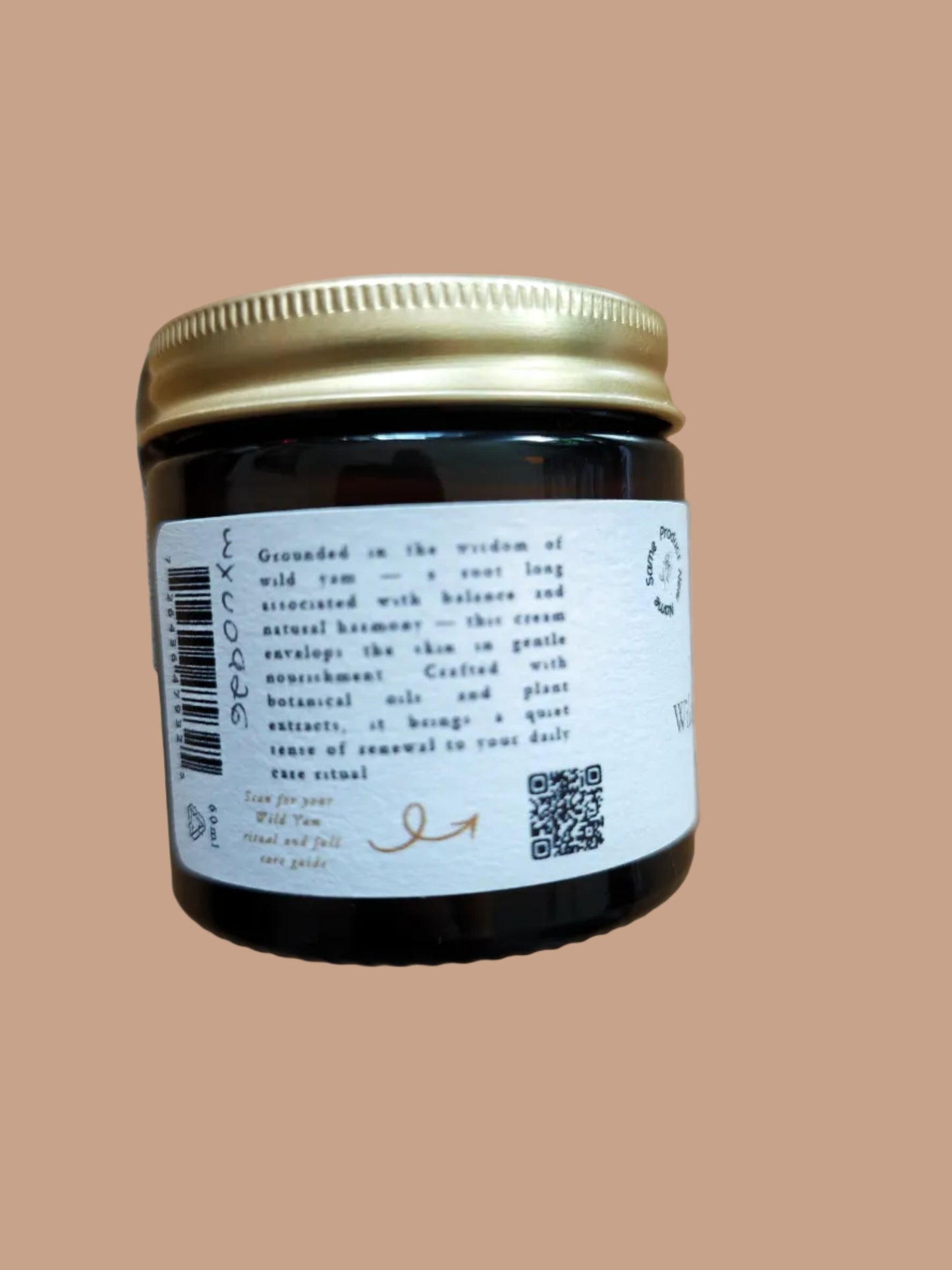 Jar with a label and gold lid on a wooden surface