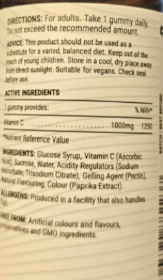 Close-up of a gummy candy package showing printed text including directions, active ingredients, and allergens on a white background.