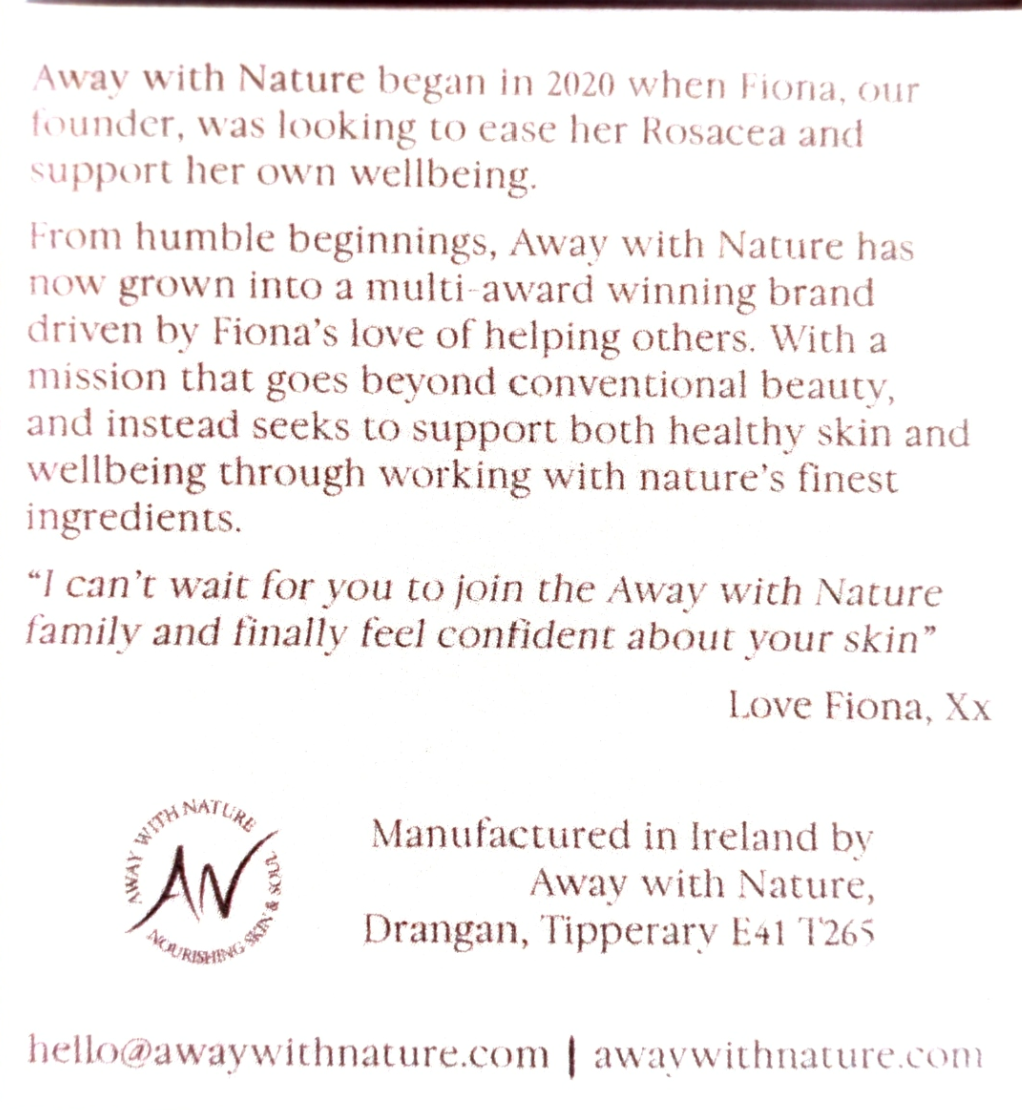 A close-up of a white card or label with printed brown text about the brand Away with Nature, including a quote from Fiona, manufacturing details in Ireland, and website contact information.