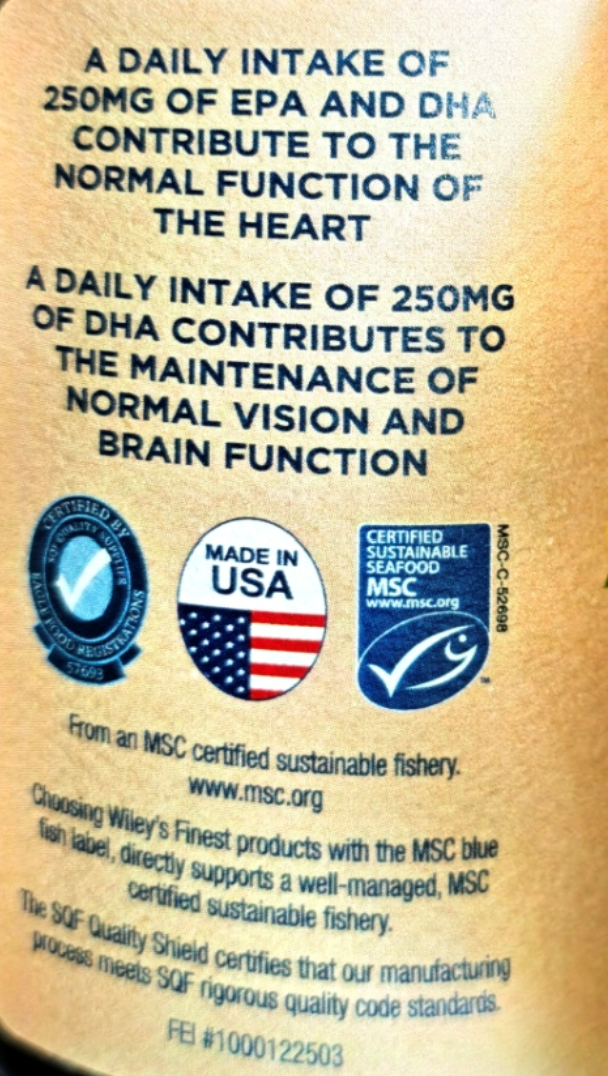 Close-up of a product label with blue text on a beige background, featuring EPA and DHA claims, MSC certification logos, a Made in USA seal, and a Wiley brand statement.