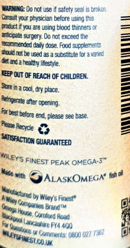 Close-up of the back of a supplement package showing text and branding for Wiley's Finest Peak Omega-3, including usage warnings, storage instructions, a recycling symbol, and a barcode.