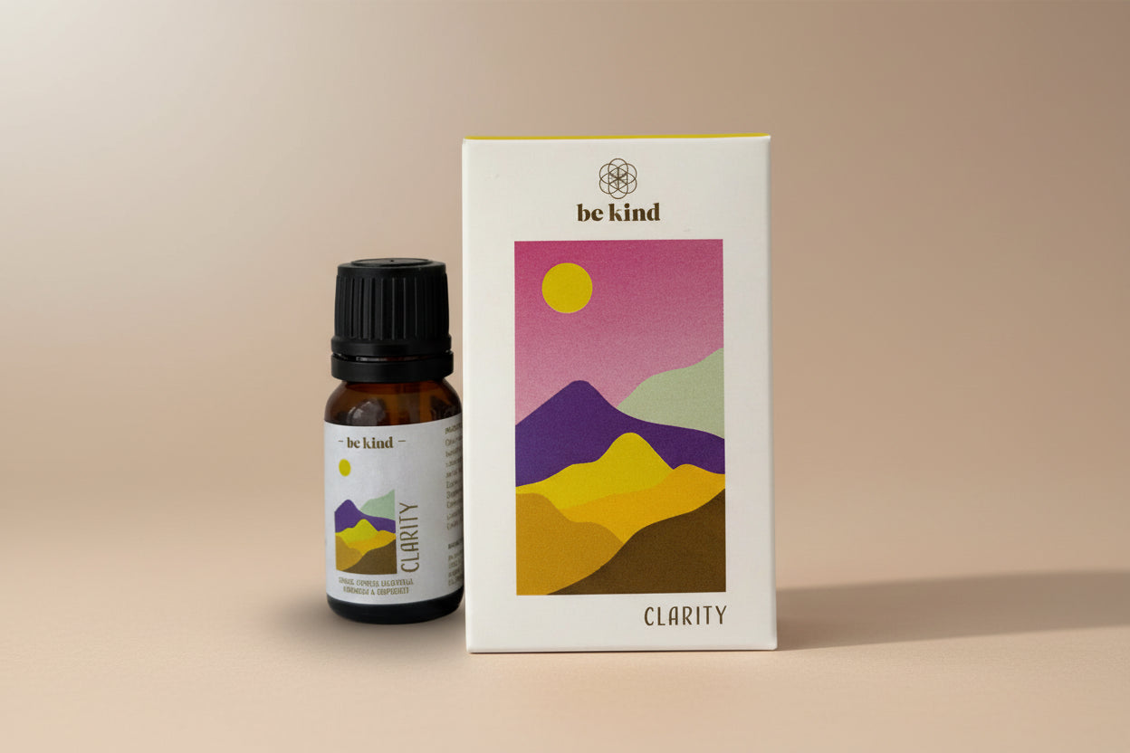 Bottle and box of 'be kind' Clarity product with mountain design on a white background