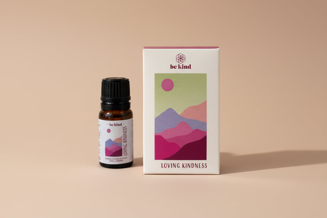 Bottle and box of 'Loving Kindness' essential oil with abstract mountain design on a white background
