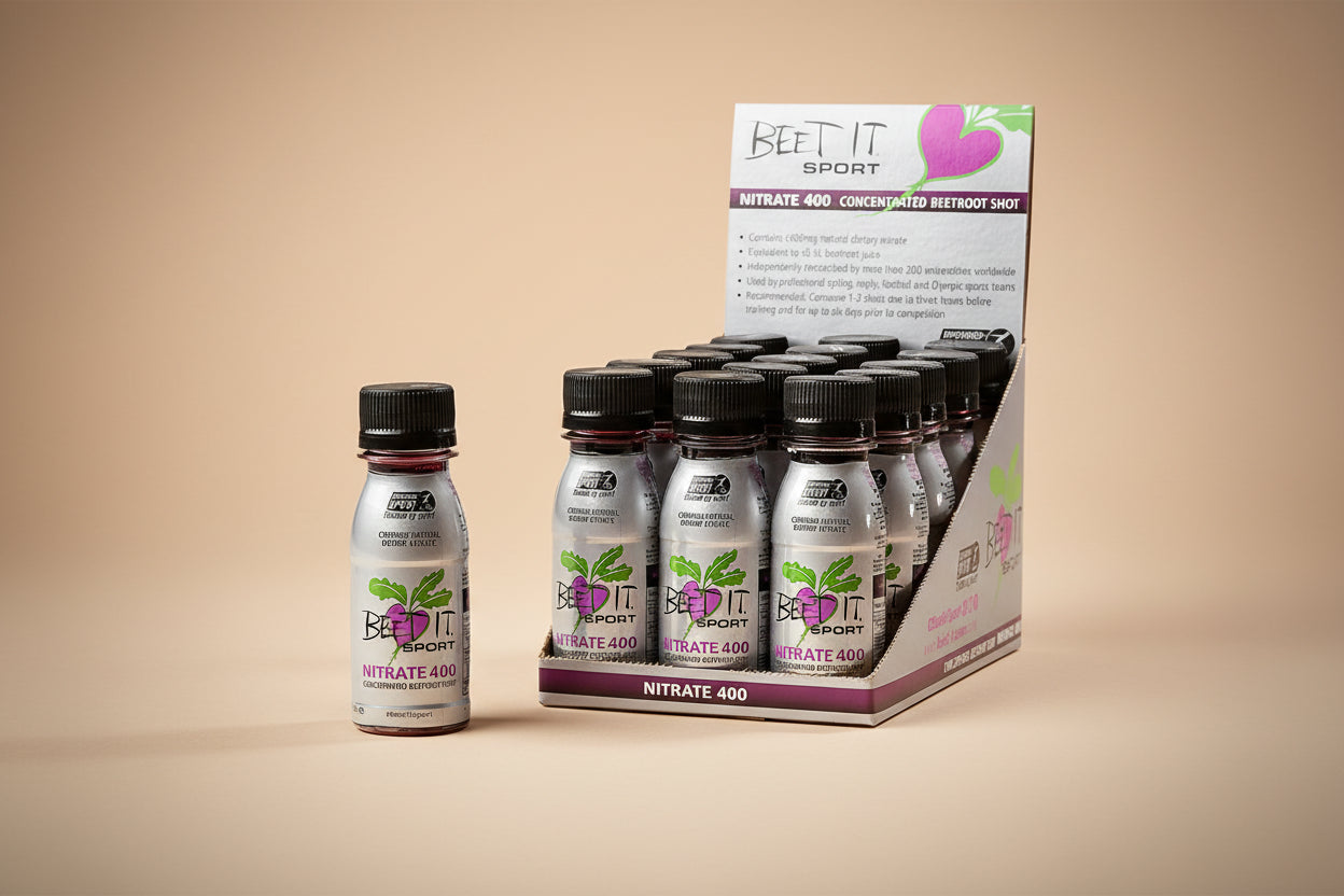 Beetroot shot bottles with packaging labeled 'Beet It Sport' on a white background