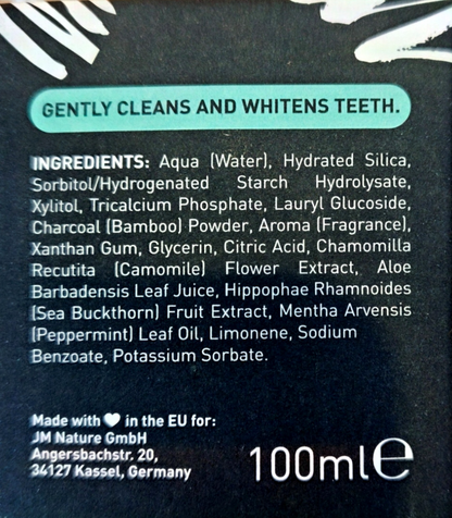 Close-up of the back of a dark toothpaste or dental care tube showing the ingredients list in white text on a black background, with a teal banner at the top reading 'GENTLY CLEANS AND WHITENST TEETH.'.