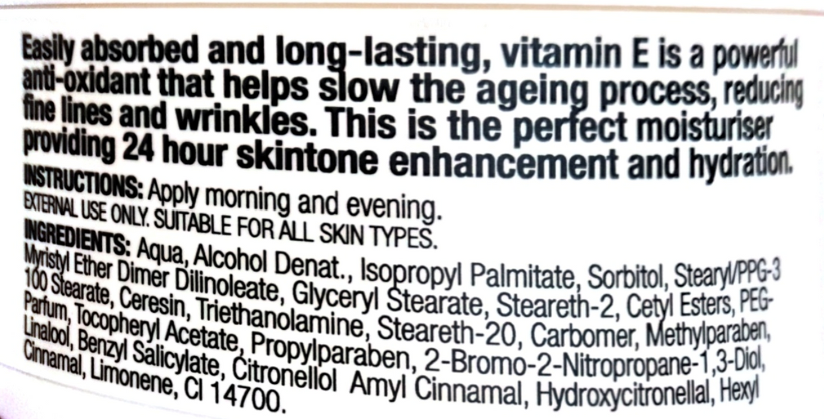 Close-up of a product label showing text about vitamin E benefits and ingredients on a white background.