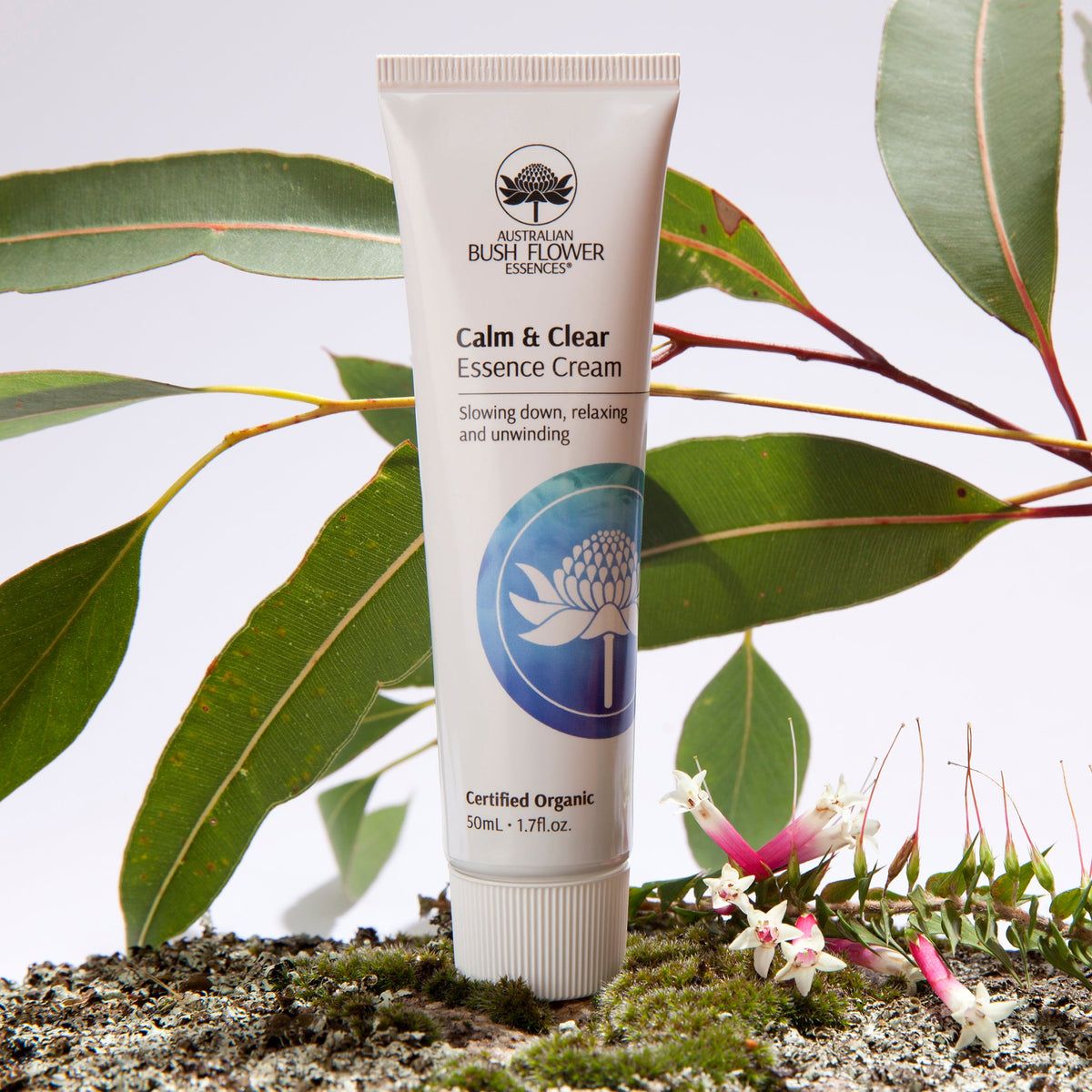 Australian Bush Flower cream tube displayed beside flowers