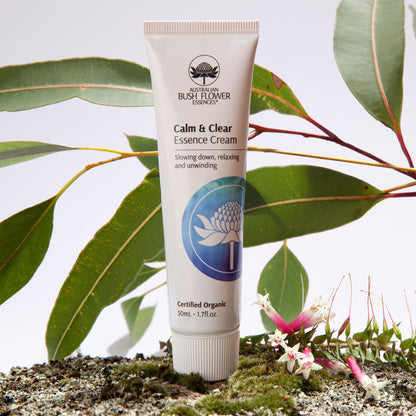 Australian Bush Flower cream tube displayed beside flowers