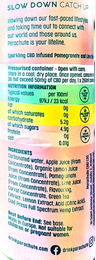 A close-up of a cylindrical beverage can showing the back label, with a colorful gradient background transitioning from pink to orange to light blue. The label contains text about slowing down fast-paced lifestyles with CBD, along with nutrition facts and ingredients including carbonated water, apple juice, organic lemon juice, pomegranate, lime juice, green tea extract, and hemp extract.