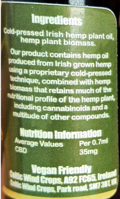Close-up of a dark green label showing product ingredients and nutrition information for cold-pressed Irish hemp plant oil and biomass, with CBD average values of 35mg per 0.7ml.