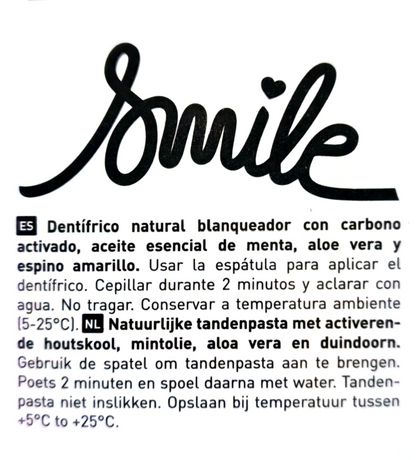 A close-up of a white product box or booklet cover showing the brand name 'Smile' in large black script at the top, followed by Spanish and Dutch product instructions in smaller black text.