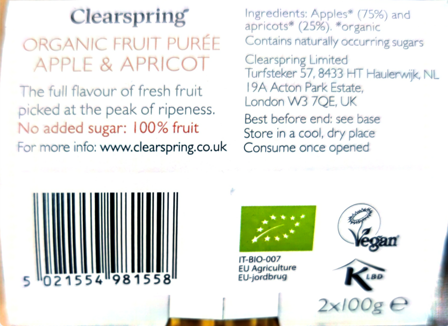 Back of a Clearspring Organic Fruit Purée Apple & Apricot package showing text, a barcode, a green organic certification logo, a vegan symbol, and a KBLD logo on a white background.