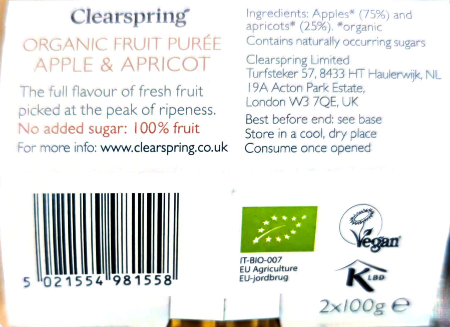 Back of a Clearspring Organic Fruit Purée Apple & Apricot package showing text, a barcode, a green organic certification logo, a vegan symbol, and a KBLD logo on a white background.
