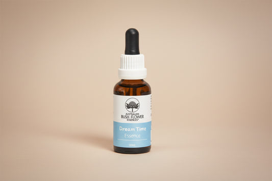 Bottle of 'Dream Time' Essence with a white cap on a white background