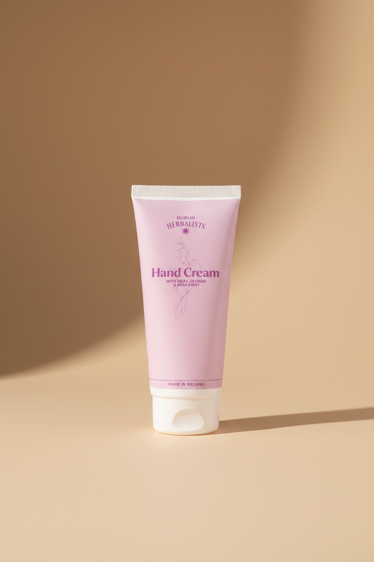 A light pink squeeze tube of Dublin Herbalists Hand Cream with white cap, on a clean white background.