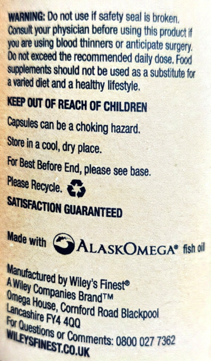 Back of a supplement package showing warning text, storage instructions, a recycling symbol, and manufacturer details for Wiley's Finest by Alaska Omega fish oil.
