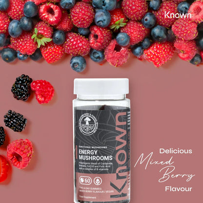 "Energy Mushrooms Gummies VEGAN bottle surrounded by berries, emphasizing the delicious Mixed Berry flavor."