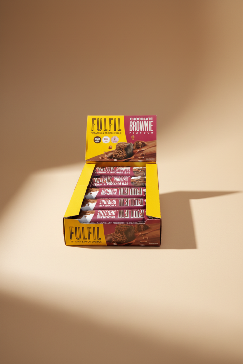 A display box of FULFIL Chocolate Brownie Flavour Vitamin & Protein Bars, showing multiple individually wrapped bars stacked inside a yellow cardboard container.