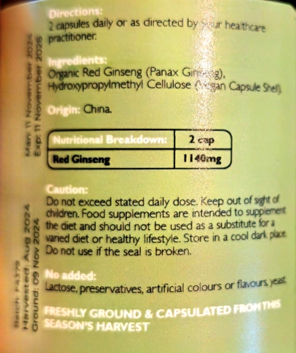 Close-up of a supplement package showing text including directions, ingredients, nutritional breakdown for 2 capsules of red ginseng, and caution information on a pale yellow background.