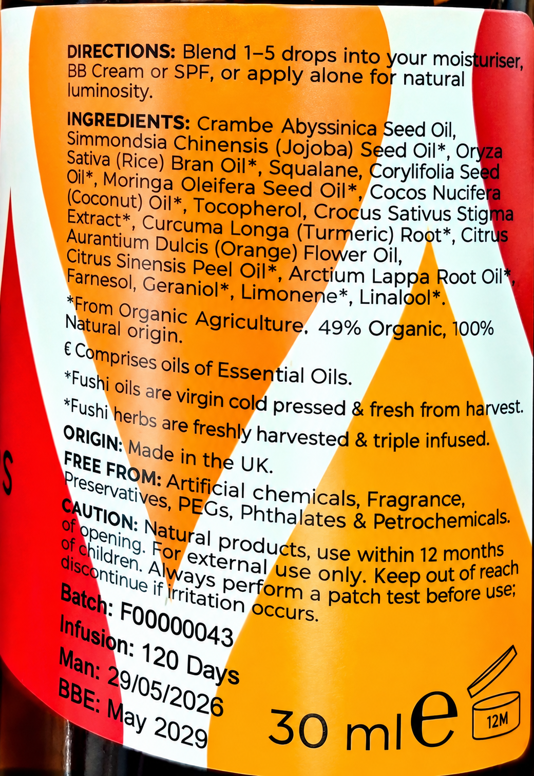 Close-up of a skincare bottle label showing product details including directions, ingredients list, origin, batch number, and usage information on a white background.
