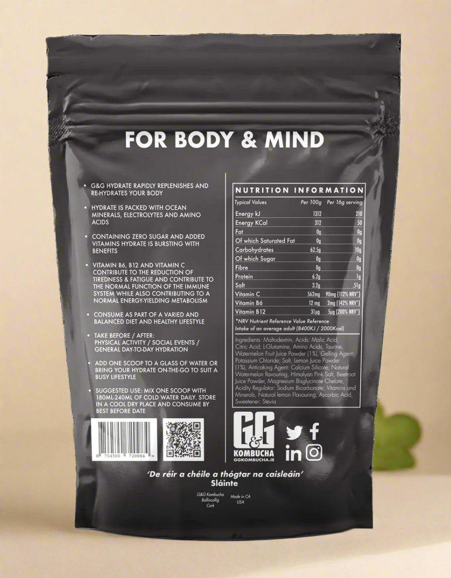Scoop of G&G Hydrate Kombucha powder with vibrant mix of pink minerals and aminos
