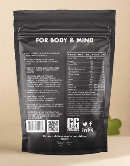 Scoop of G&G Hydrate Kombucha powder with vibrant mix of pink minerals and aminos