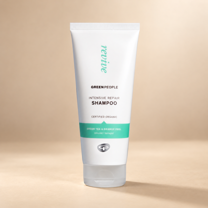 Green People Intensive Repair Shampoo 200ml tube on a warm beige background