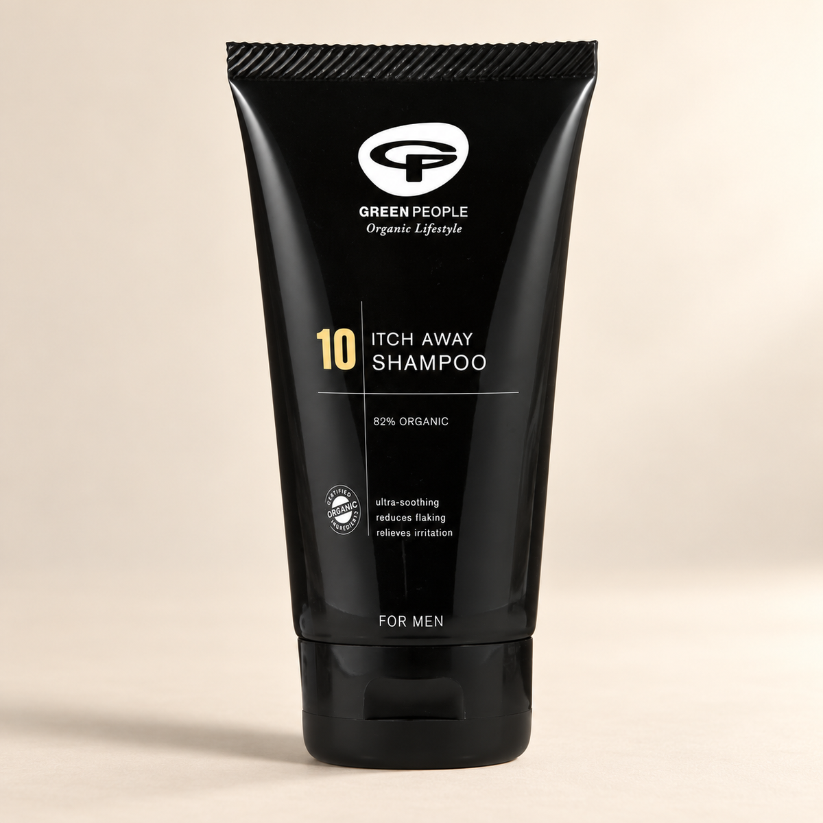 Green People No.10 Itch Away Shampoo 125ml – original black tube on a warm cream background