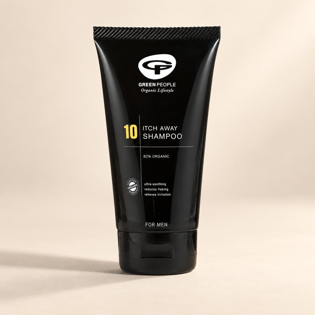 Green People No.10 Itch Away Shampoo 125ml – original black tube on a warm cream background