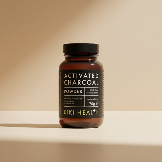 A black bottle labeled 'ACTIVATED CHARCOAL POWDER' made from coconut shells by KIKI HEALTH, containing 70g of the product.
