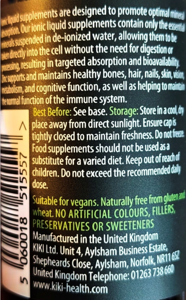 Close-up of a dark green liquid supplement bottle label showing product information, a barcode, and text in black, yellow, and green.