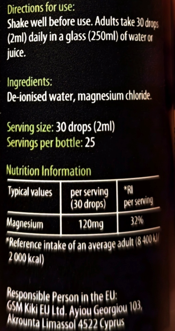 Close-up of a supplement bottle label showing directions for use, ingredients, serving size, nutrition information table, and responsible person in the EU text on a dark background.