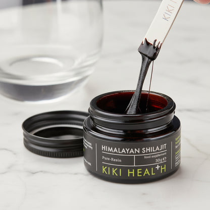Kiki Himalayan Shilajit resin in an open jar with a dropper