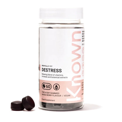 "Front view of Known Destress Gummies VEGAN, 60-count bottle with a couple of gummies around it."