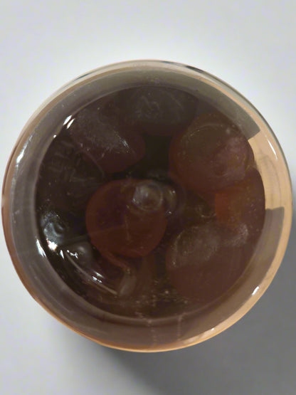 "Bottom view of the Known Pregnancy Support Gummies VEGAN bottle, showcasing the actual raspberry-flavored gummies inside."