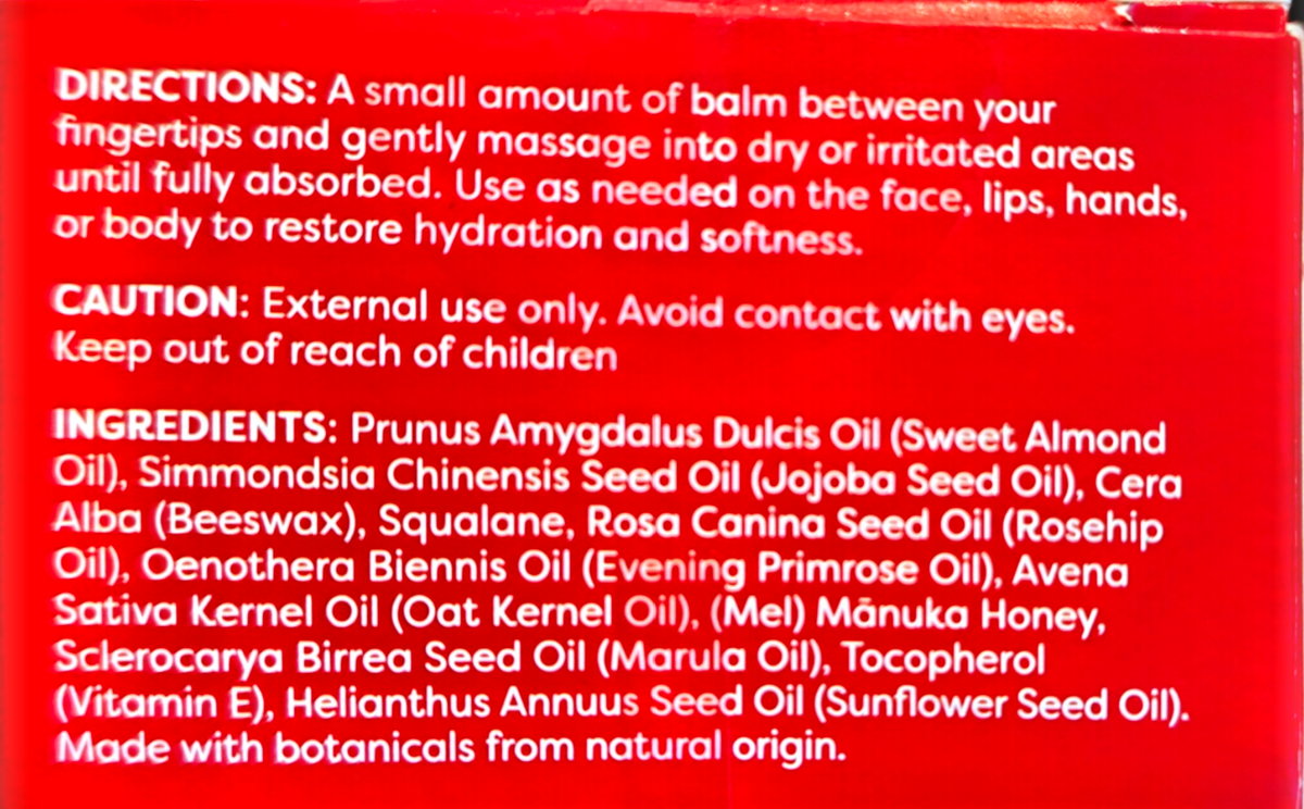 Close-up of a red product box showing white printed text with directions, caution, and ingredients in Finnish.