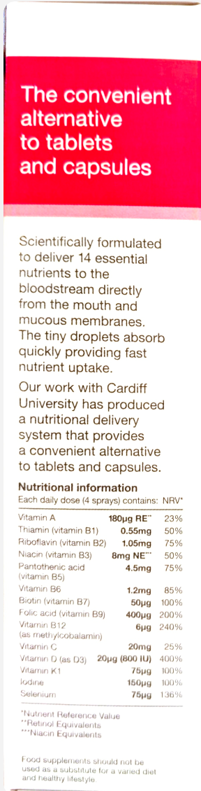 A close-up of a white printed supplement facts panel with red and black text, showing product information and nutritional details for a liquid supplement.