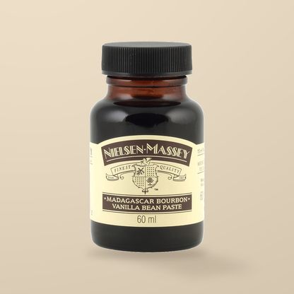 Nielsen-Massey Madagascar Bourbon Vanilla Bean Paste – 60ml — original product packaging on warm beige background